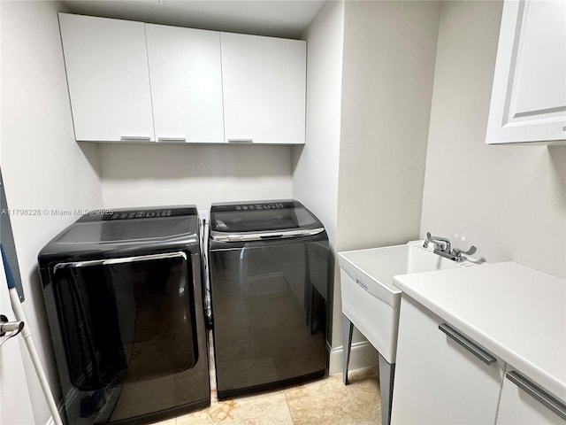 laundry area featuring independent washer and dryer and cabinet space