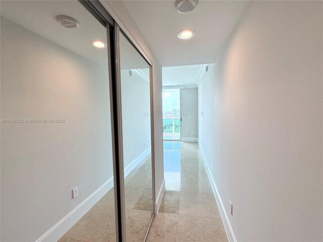 hallway with baseboards and recessed lighting
