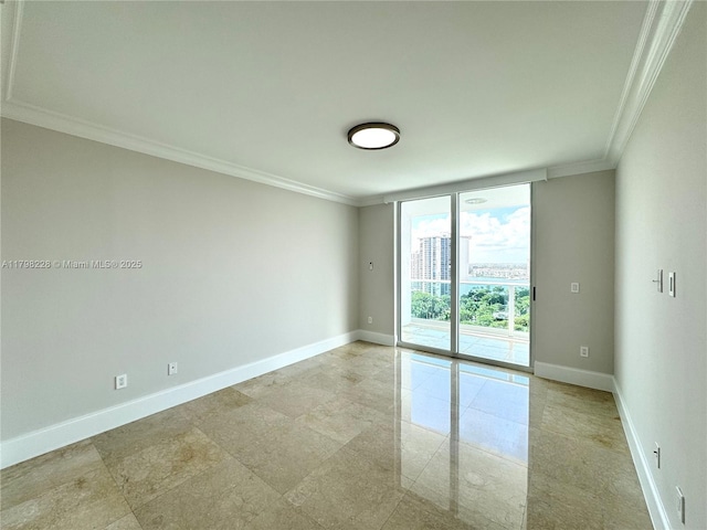 spare room with baseboards, a wall of windows, and ornamental molding
