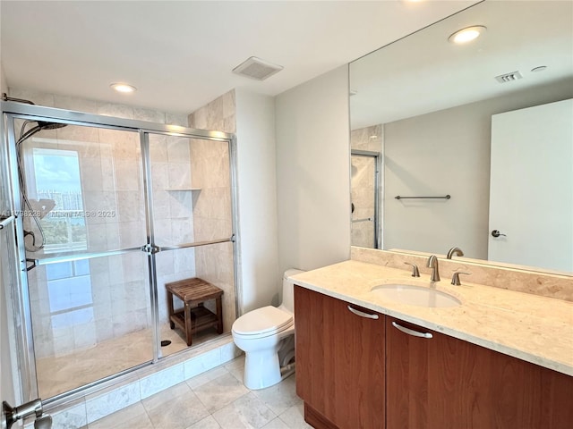 bathroom with toilet, vanity, visible vents, and a stall shower