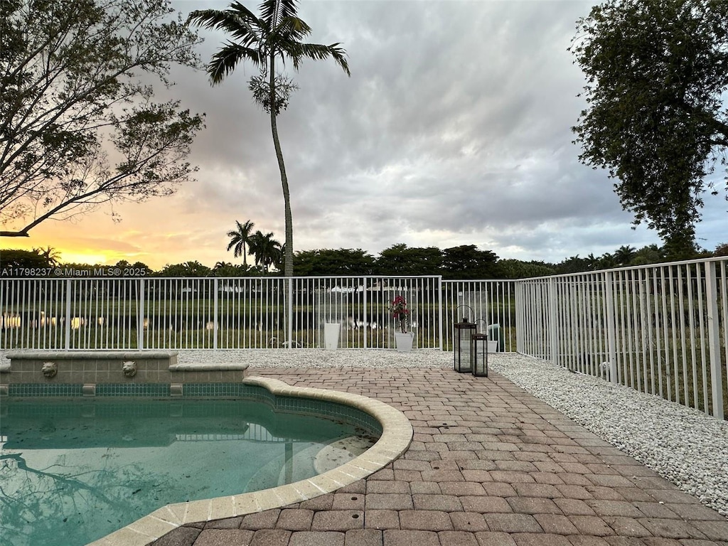1048 SE Sunflower Cir, Weston, FL 33327 - view of pool featuring a fenced backyard, a patio area, and a fenced in pool