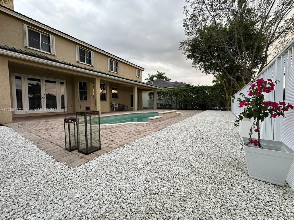 1048 SE Sunflower Cir, Weston, FL 33327 - pool featuring a fenced backyard, a patio area, and french doors