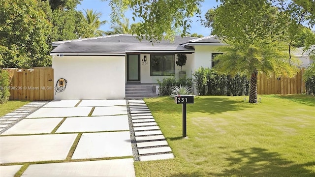 231 NE 45th St, Miami, FL 33137 - view of front facade with a front yard, stucco siding, a tiled roof, and fence