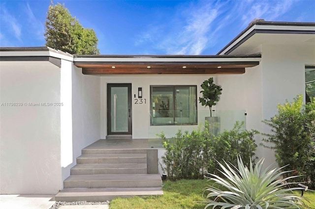 231 NE 45th St, Miami, FL 33137 - property entrance featuring a porch and stucco siding