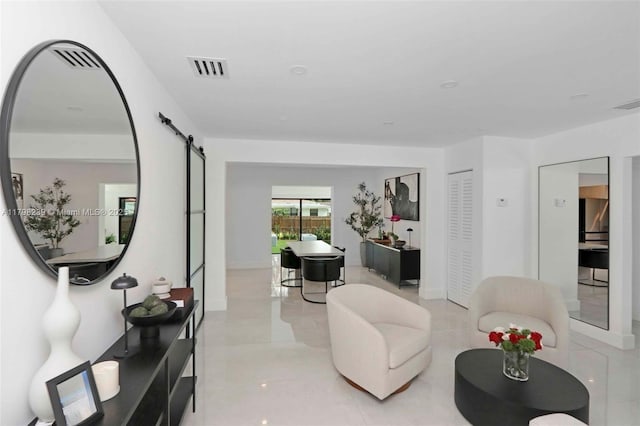231 NE 45th St, Miami, FL 33137 - living room featuring a barn door and visible vents