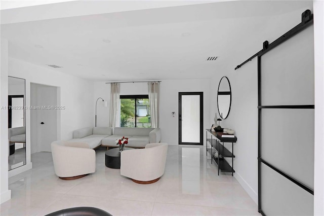 231 NE 45th St, Miami, FL 33137 - living area with light tile patterned flooring, a barn door, baseboards, and visible vents