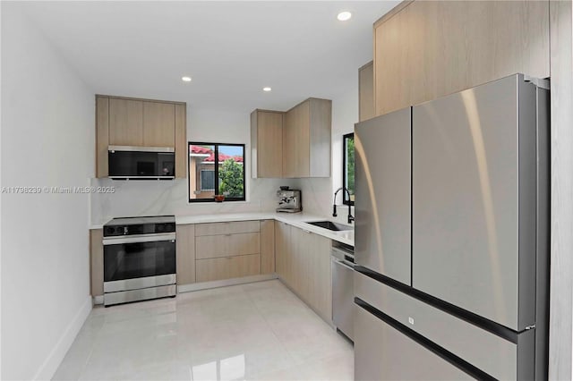 231 NE 45th St, Miami, FL 33137 - kitchen featuring a sink, stainless steel appliances, light countertops, light brown cabinets, and modern cabinets