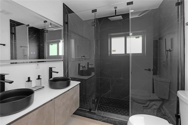 231 NE 45th St, Miami, FL 33137 - bathroom featuring toilet, a sink, and a marble finish shower