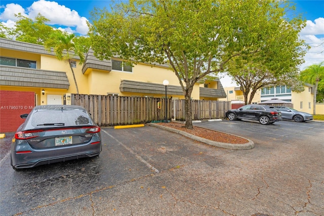 8425 SW 137th Ave Unit 8425, Miami, FL 33183 - uncovered parking lot featuring fence