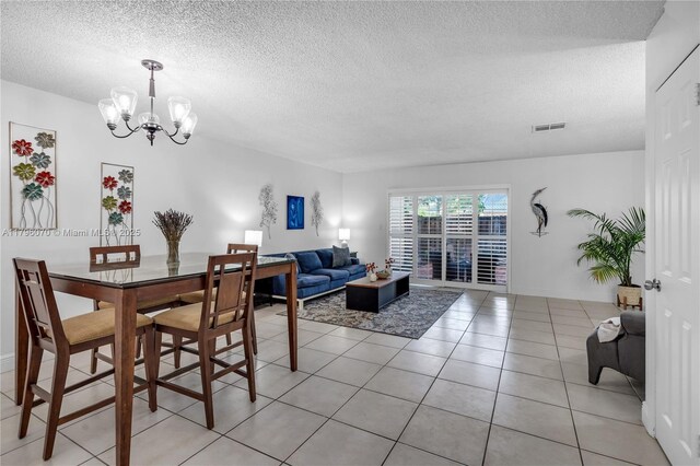 8425 SW 137th Ave Unit 8425, Miami, FL 33183 - dining space with a chandelier, a textured ceiling, and light tile patterned floors