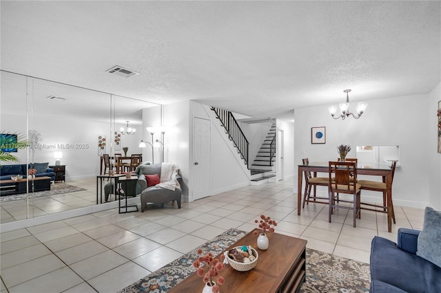8425 SW 137th Ave Unit 8425, Miami, FL 33183 - living room with a chandelier, stairway, a textured ceiling, light tile patterned flooring, and baseboards
