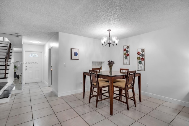 8425 SW 137th Ave Unit 8425, Miami, FL 33183 - dining area with a chandelier, a textured ceiling, light tile patterned floors, baseboards, and stairs