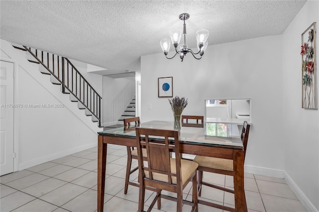 8425 SW 137th Ave Unit 8425, Miami, FL 33183 - dining space with stairs, a textured ceiling, a chandelier, light tile patterned flooring, and baseboards