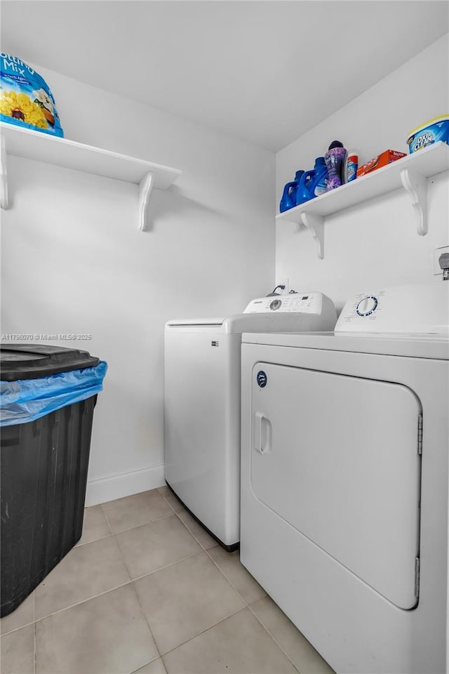8425 SW 137th Ave Unit 8425, Miami, FL 33183 - clothes washing area featuring washing machine and clothes dryer, light tile patterned floors, and baseboards