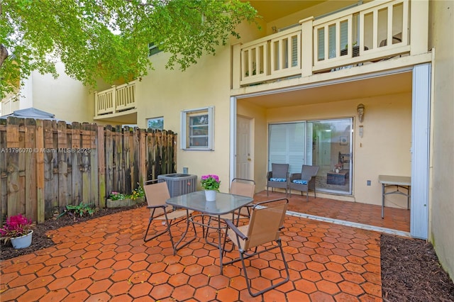 8425 SW 137th Ave Unit 8425, Miami, FL 33183 - view of patio featuring fence, outdoor dining space, central AC, and a balcony