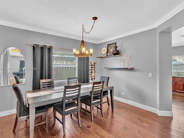 10273 SW 16th Ct, Pembroke Pines, FL 33025 - dining room with a chandelier, plenty of natural light, crown molding, baseboards, and wood finished floors