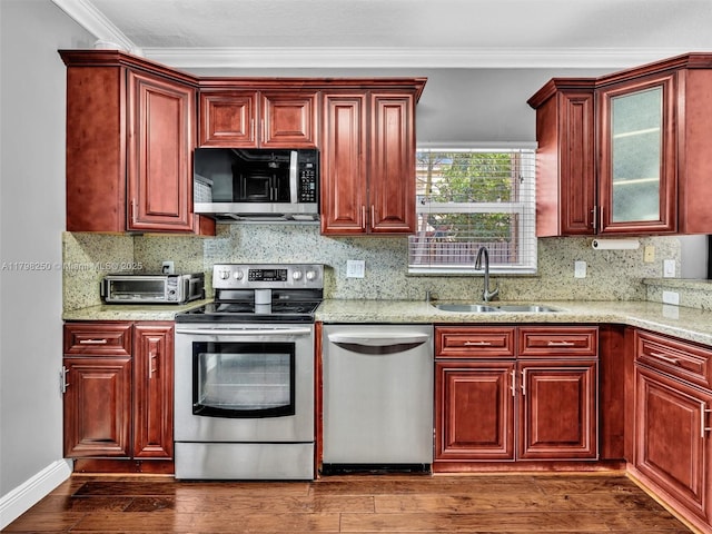 10273 SW 16th Ct, Pembroke Pines, FL 33025 - kitchen featuring appliances with stainless steel finishes, reddish brown cabinets, a sink, and crown molding