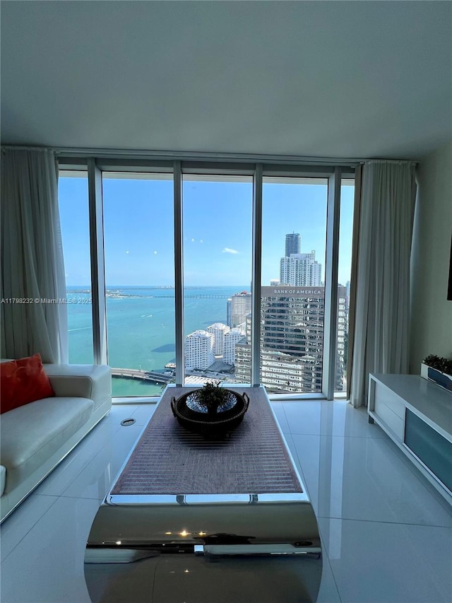 tiled living area with a water view and a city view