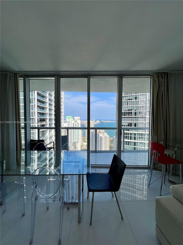 dining space featuring a wall of windows and a city view