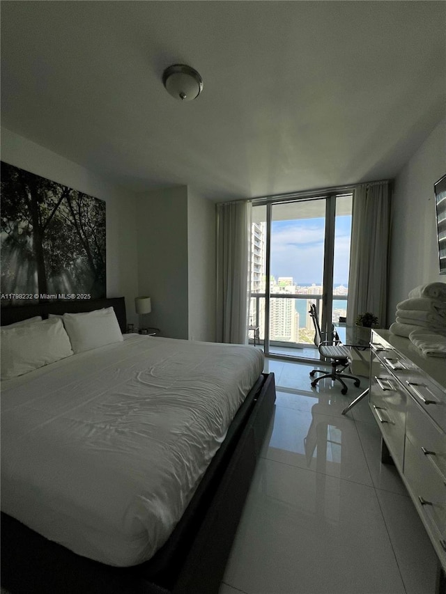 bedroom with a wall of windows and access to outside