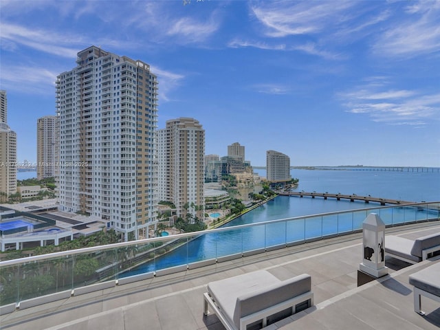 view of swimming pool featuring a city view and a water view
