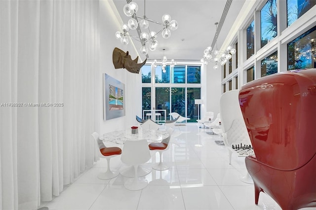tiled dining room with a chandelier and a towering ceiling
