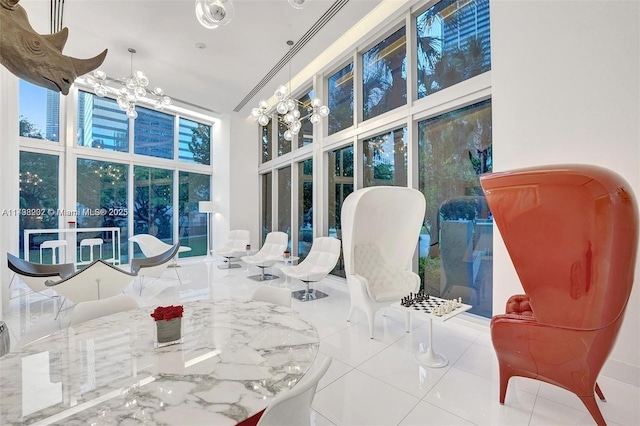 sunroom / solarium featuring a chandelier