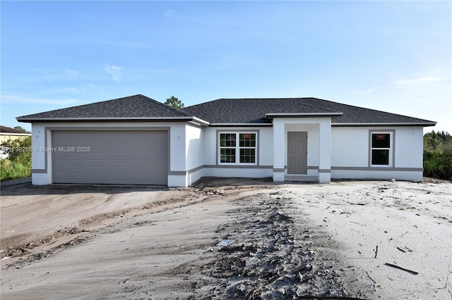 4463 60th Ave NE, Naples, FL 34120 - view of front of home featuring roof with shingles, stucco siding, and a garage
