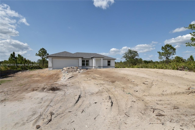 4463 60th Ave NE, Naples, FL 34120 - view of front facade featuring a garage and stucco siding