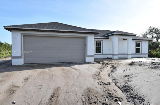4463 60th Ave NE, Naples, FL 34120 - view of front of home with stucco siding and roof with shingles