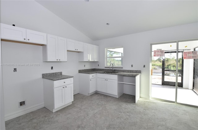 4463 60th Ave NE, Naples, FL 34120 - kitchen featuring vaulted ceiling and white cabinetry