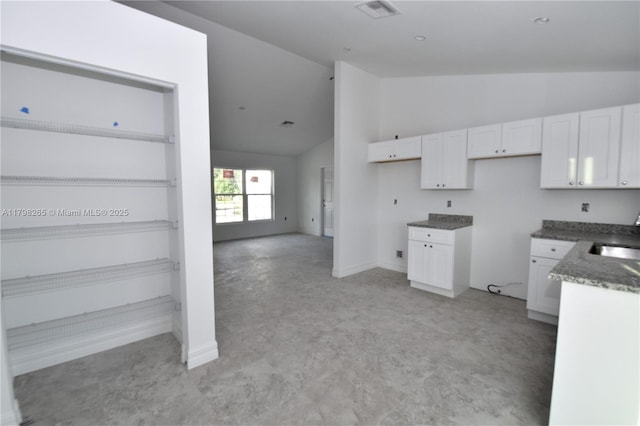 4463 60th Ave NE, Naples, FL 34120 - kitchen with white cabinetry, high vaulted ceiling, light colored carpet, and dark stone counters
