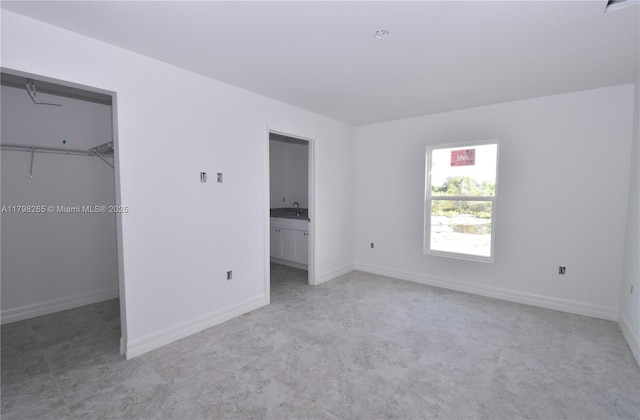4463 60th Ave NE, Naples, FL 34120 - unfurnished bedroom featuring a spacious closet, light carpet, and a closet