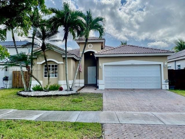 13851 SW 156th Ave, Miami, FL 33196 - view of front facade with decorative driveway, stucco siding, an attached garage, and a tile roof