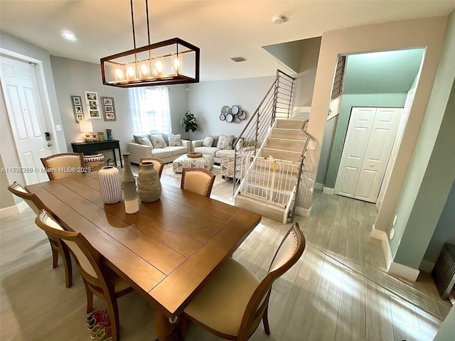 dining room with light wood-type flooring, baseboards, and recessed lighting