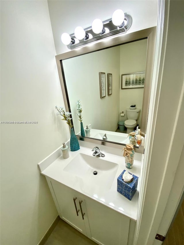 half bath featuring toilet and vanity
