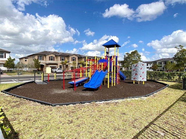 community play area with fence and a residential view