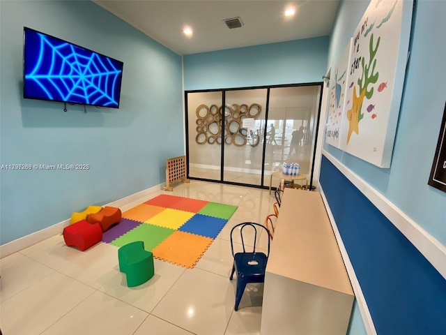 recreation room with baseboards and recessed lighting