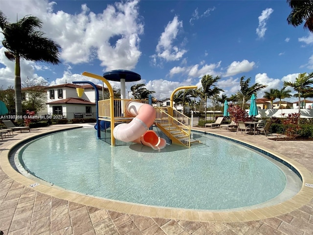 view of swimming pool featuring a water play area and a water slide