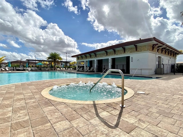 community pool featuring a patio area and fence