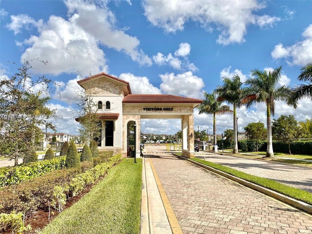 surrounding community featuring decorative driveway