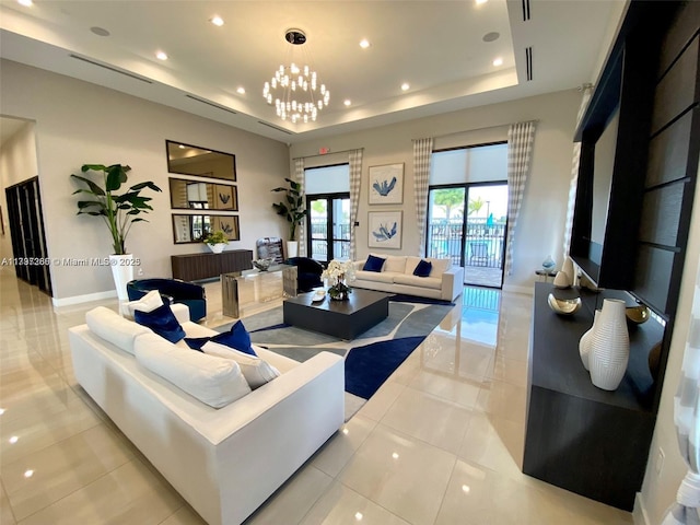 living room with a tray ceiling, recessed lighting, light tile patterned flooring, a chandelier, and baseboards
