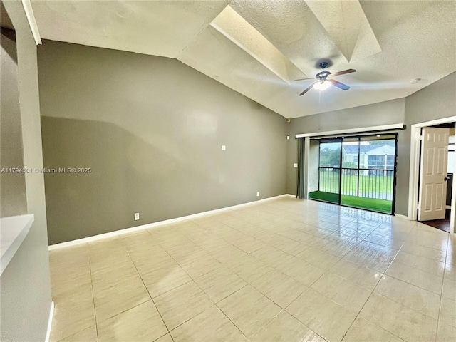 tiled spare room with vaulted ceiling, a ceiling fan, a textured ceiling, and baseboards