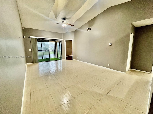 spare room with light tile patterned floors, a ceiling fan, and vaulted ceiling