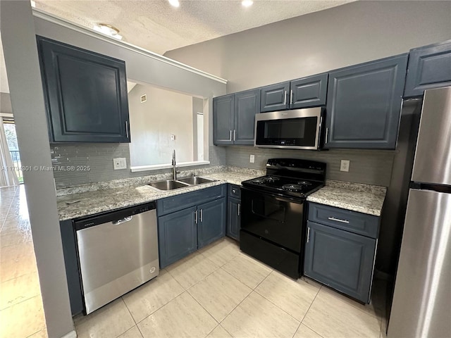 kitchen featuring stainless steel appliances, a sink, tasteful backsplash, light tile patterned floors, and a textured ceiling