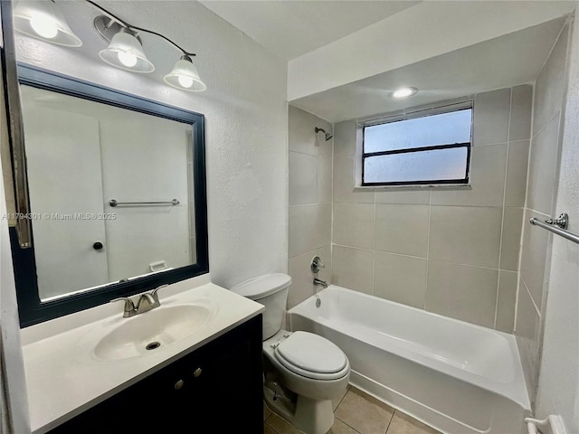 full bath featuring toilet, a textured wall, vanity, tile patterned floors, and bathtub / shower combination