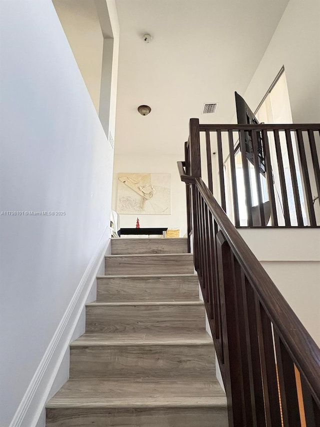 staircase with wood finished floors