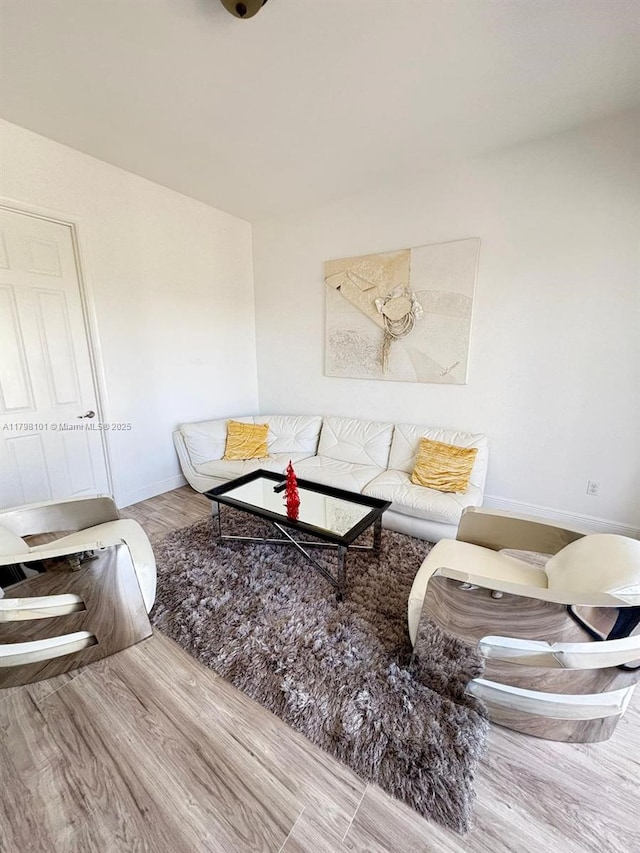 living area featuring wood finished floors and baseboards