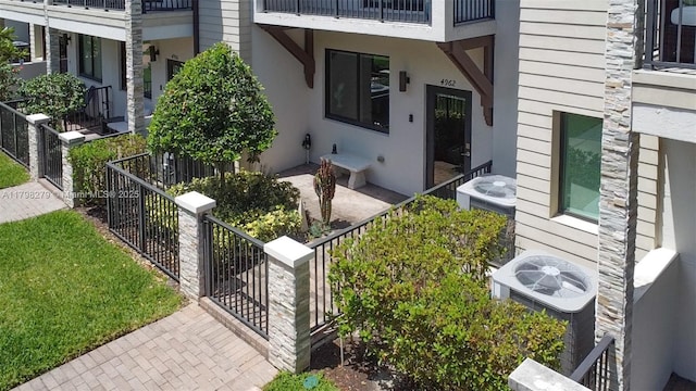 4962 NW 83rd Path Unit 4962, Doral, FL 33166 - view of exterior entry with stone siding, central air condition unit, and stucco siding