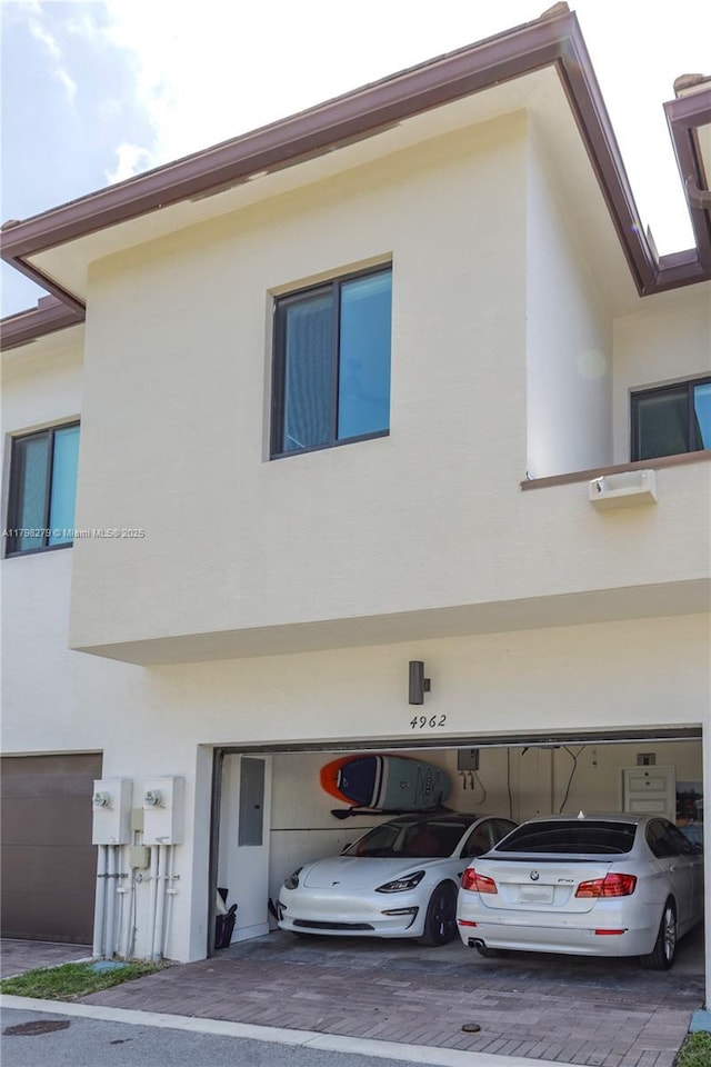 4962 NW 83rd Path Unit 4962, Doral, FL 33166 - view of front of house with stucco siding, a garage, and decorative driveway